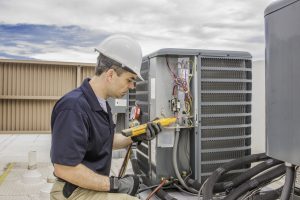 Trained hvac technician holding a voltage meter